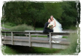 Painterly version of wedding couple on wooden bridge